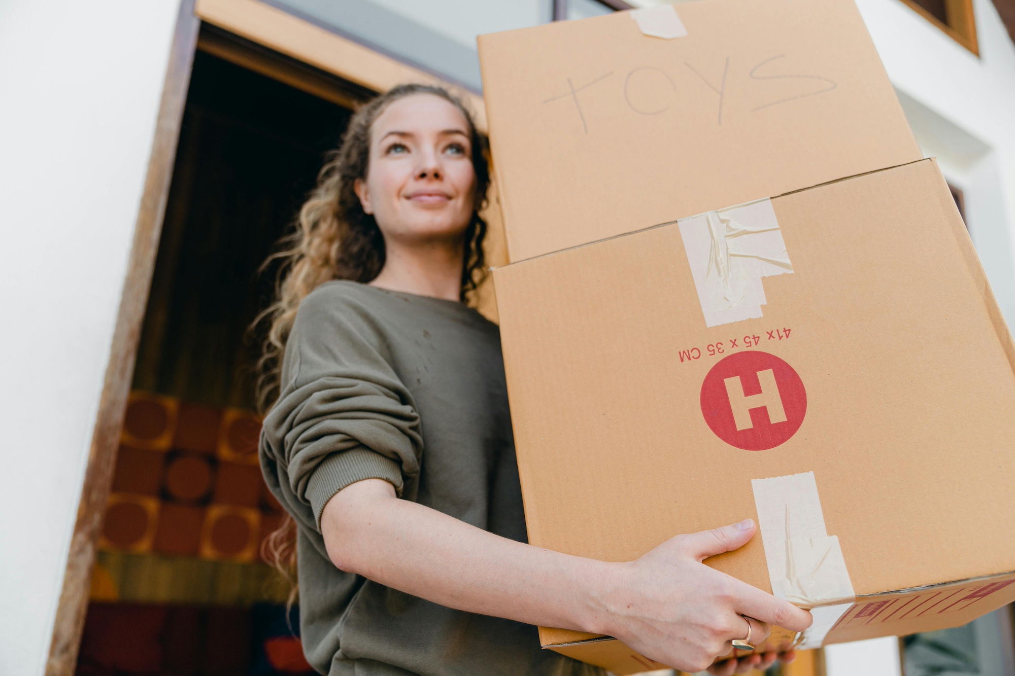 girl moving two boxes into a storage facility